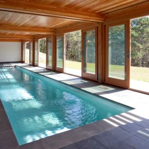 indoor swimming pool with doors that open to outside