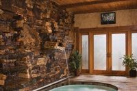 29 kidney-shaped indoor pool with a small waterfall