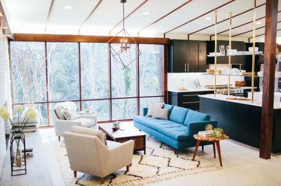 An interesting mid-century inspired interior where a living area and a kitchen are both located on the second floor.
