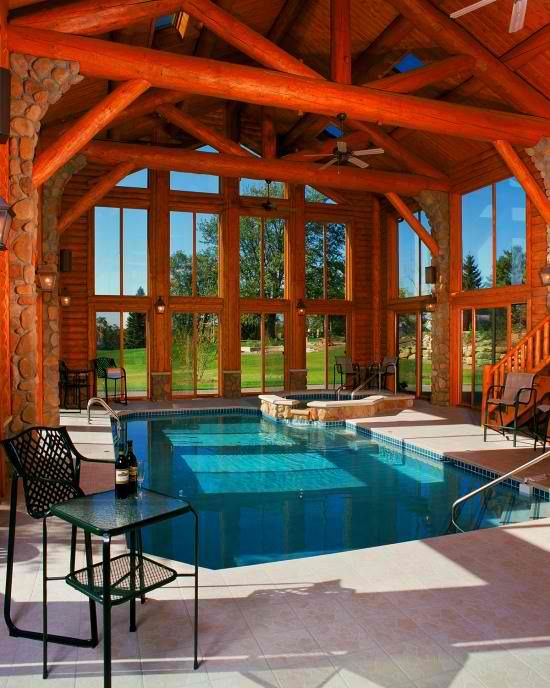 small indoor pool inside a cabin with wooden beams