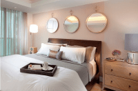 32 identical round mirrors above the bed