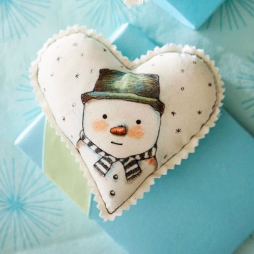 A white felt heart shaped Christmas ornament with a painted snowman is a lovely and cool idea for holiday decor