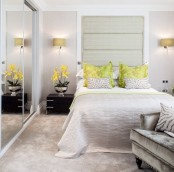 an oversized horizontal headboard over the bed and a glass sliding doors of the wardrobe visually expand the space a lot