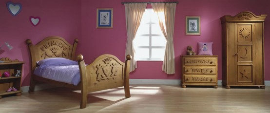 a mauve Princess themed kid's room with carved wooden furniture and touches of blue