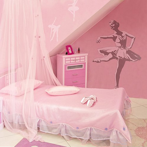 A pink ballerina inspired kid's room with a canopy bed and a ballet dancer art on the wall