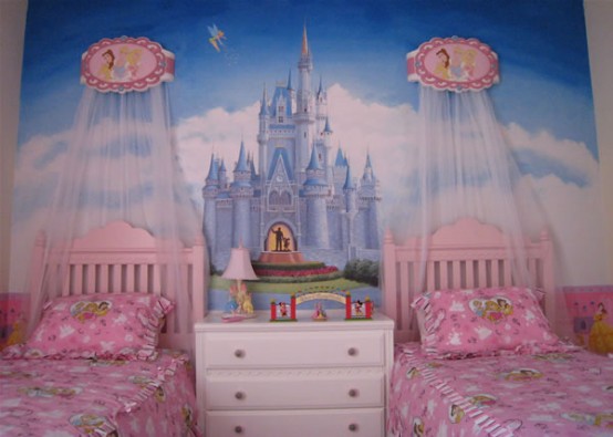 a princess castle-inspired girl's bedroom with a castle artwork and pink beds with canopies is a very dreamy space