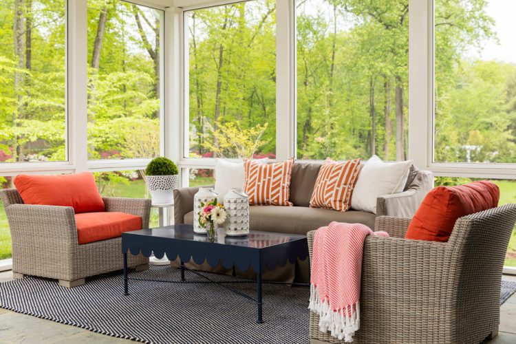 a classic choice of seating furniture for a sunroom with colorful pillows