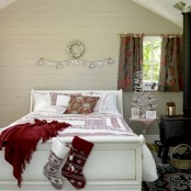 a wooden ornament bunting, red and white bedding and a mini white Christmas tree with red ornaments