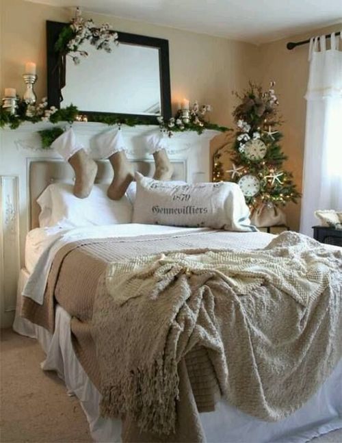 A neutral Christmas bedroom with evergreens, white blooms and cotton, candles and vintage inspired bedding with ruffles and a crochet blanket