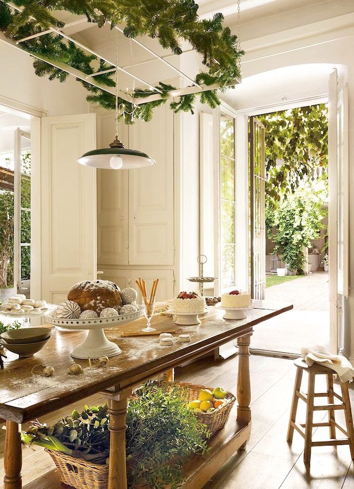 A cozy rustic kitchen with French doors thta can be opened to get some fresh air and light from the garden and enjoy the views of greenery outside