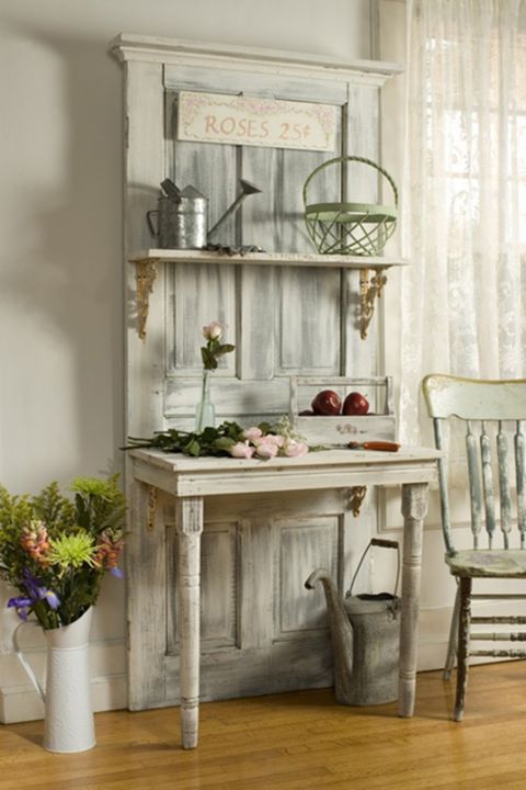 a whitewashed garden piece with a door, a shelf and a half table is a beautiful idea for a vintage or shabby chic garden