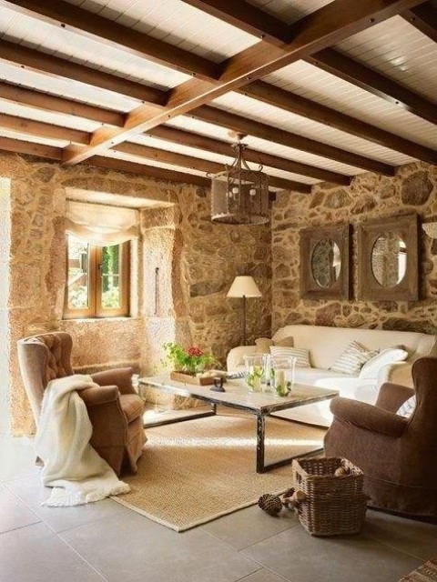a Provence-style living room with wooden beams and stone walls plus elegant vintage-inspired furniture