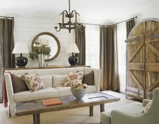 a rustic meets modern living room with wooden doors, shiplap on the wall and a reclaimed wooden coffee table