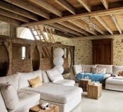 a combo of stone walls and a wooden beam ceiling is a gorgeous rustic idea to go for