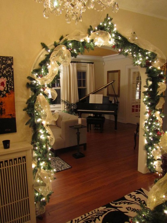 an evergreen garland with ribbon, lights and berries is great for styling an arch, a mantel or a banister