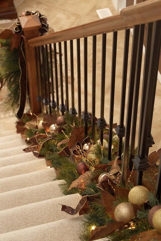 An evergreen garland with brown and gold ornaments, faux leaves and ribbon is a very eye catching idea for elegant Christmas decor