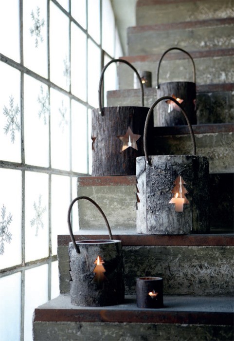 Even though it'd require some carving skills and lots of tools but lanterns made of tree trunk pieces would become the best part of your holiday decor. They are perfect to add a rustic and cozy touch to any interior. Don't forget to add some paper snowflakes on the windows.