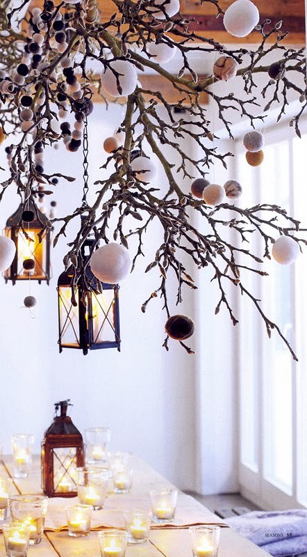 Hang some rustic lanterns on a tree branch and you've got yourself beautiful fall-winter piece of decor. Add some ornaments to it to make it Christmas ready.