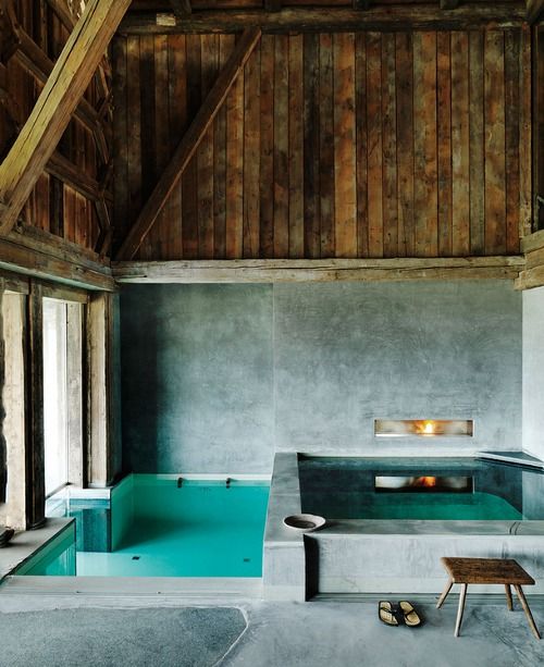a contemporary pavilion done with concrete and wood, with a pool and a hot tub is a stylish space that welcomes in to relax