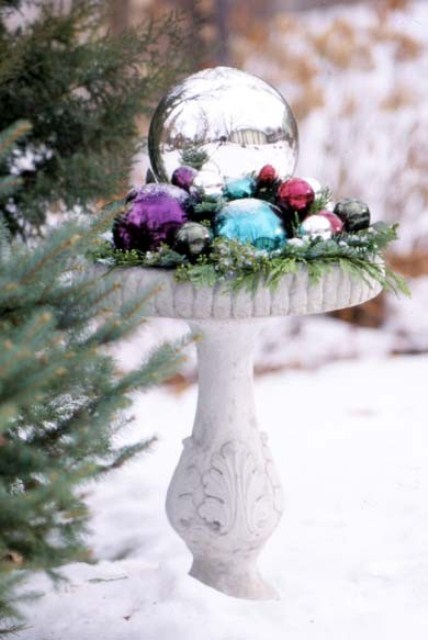 Fill your once blooming flower bed with a bunch of brightly colored ornaments to make a splash in your garden.