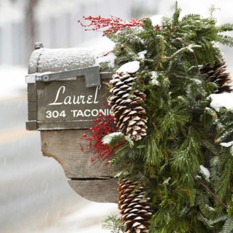 Think about a seasonal makeover for your mailbox with some evergreen branches and pine cones.