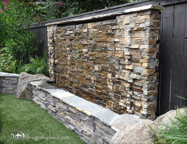 A natural stone water wall  could blend with a support wall made of the same stone nicely.