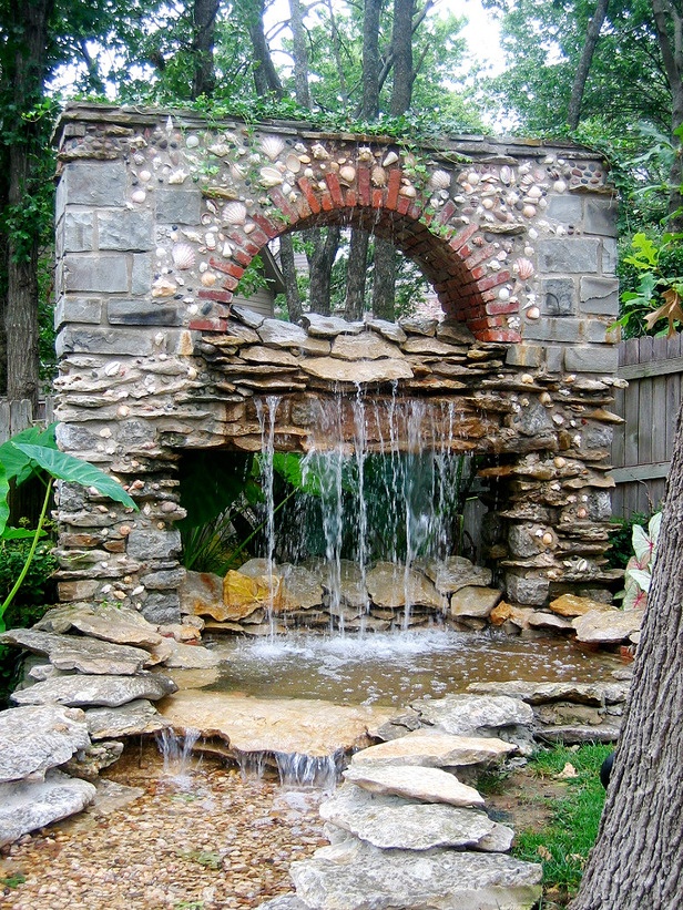 Garden waterfall imitating an old building's wall.