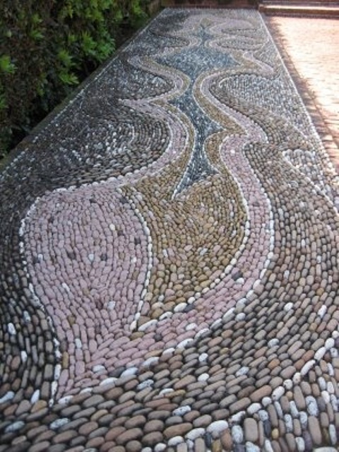 A gorgeous pebble pathway done with patterns in several colors   pink, blue and tan to add pattern and colro to your space