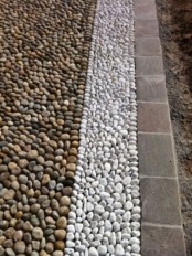a minimalist garden path made of neutral and white pebbles plus taupe bricks for lining up will give your garden a more formal feel