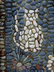 a blue pebble pathway with a white cat is a fun idea to add a personalizing touch to your garden