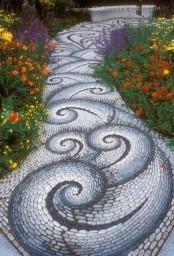 a fantastic white, grey and blue pebbles with swirl patterns is a statement idea for decorating a garden