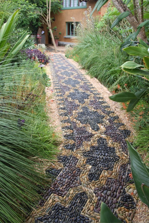 A fantastic pebble pathway done with a Moroccan pattern in yellow and burgundy looks very eye catchy and bold