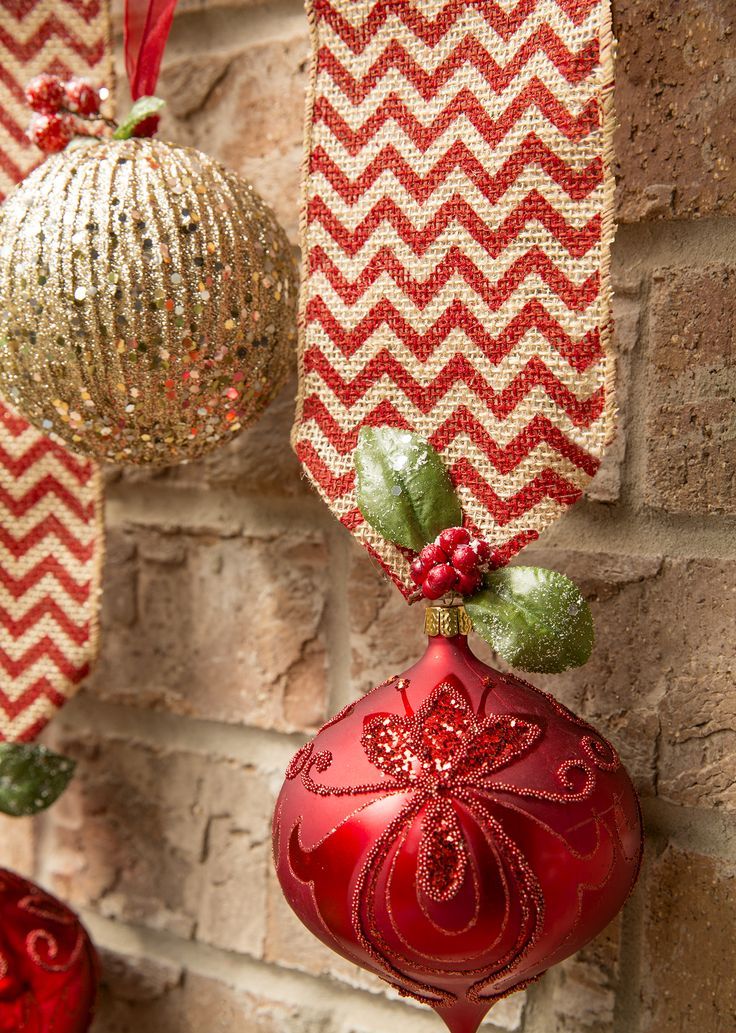 Glitter red and gold ornaments on ribbons are fun and cool to decorate a Christmas tree, door or some other space