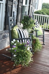 a couple of chairs with bright pillows and some potted greenery and blooms for a bold spring look