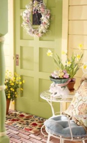 bright potted blooms and colorful fake eggs, a wreath of pastel faux eggs and colorful throws