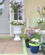 lots of potted lilac and purple blooms, white blooms and printed pillows will finish off a spring porch