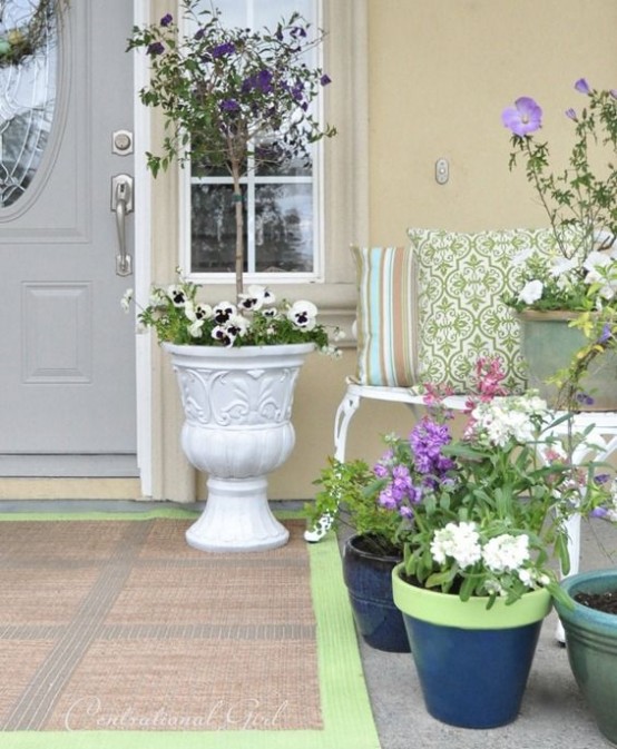 lots of potted lilac and purple blooms, white blooms and printed pillows will finish off a spring porch