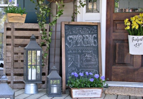 candle lanterns, a chalkboard sign and some bright potted blooms will create a fresh and bold spring feel in the space