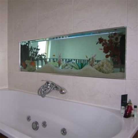 A built in aquarium over the tub is a cool decor feature to feel like swimming in the sea