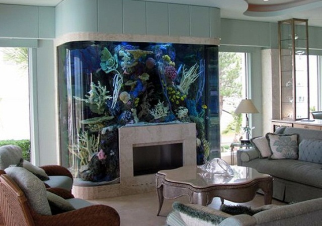 An oversized and bold aquarium over the non working fireplace is like water and fire, makes a bold and cool statement