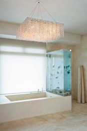 an aquarium wall on one side of your tub is a lovely idea to relax and feel like swimming in the sea