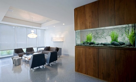 a long no fish aquarium  clad with rich stained wood is a stylish decor feature and as a space divider