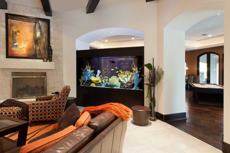 A built in aquarium adds a vibrant and natural feel to the living room decor
