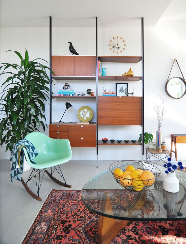 A sleek mid century modern wall unit with drawers and closed compartments, open shelves is a very comfy and stylish idea