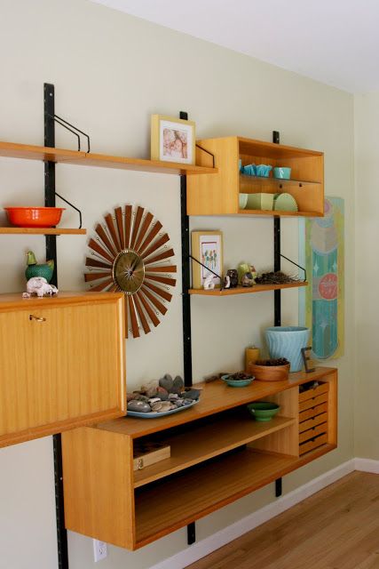 A chic and lightweight wall mounted shelving unit with open shelves and open box shelves plus some drawers