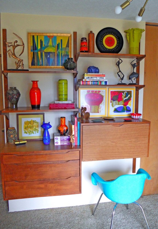 a rich stained mid-century modern wall unit with open shelves, a closed compartment and a bureau that features a desk