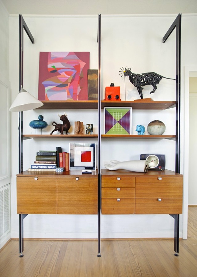 A bold mid century modern wall unit with dark metal touches, cabinets and open shelves and drawers