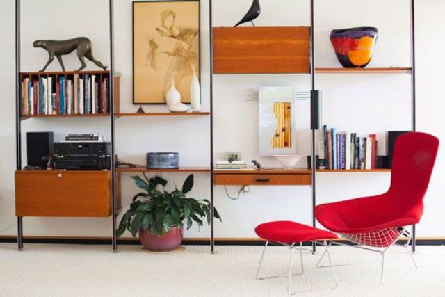 A mid century modern wall unit with drawers and cabinets, open shelves and a bookshelf