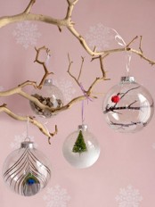 grab sheer glass ornaments and fill them with whatever you like – feathers, mini trees, faux snow and so on to create a cool combo