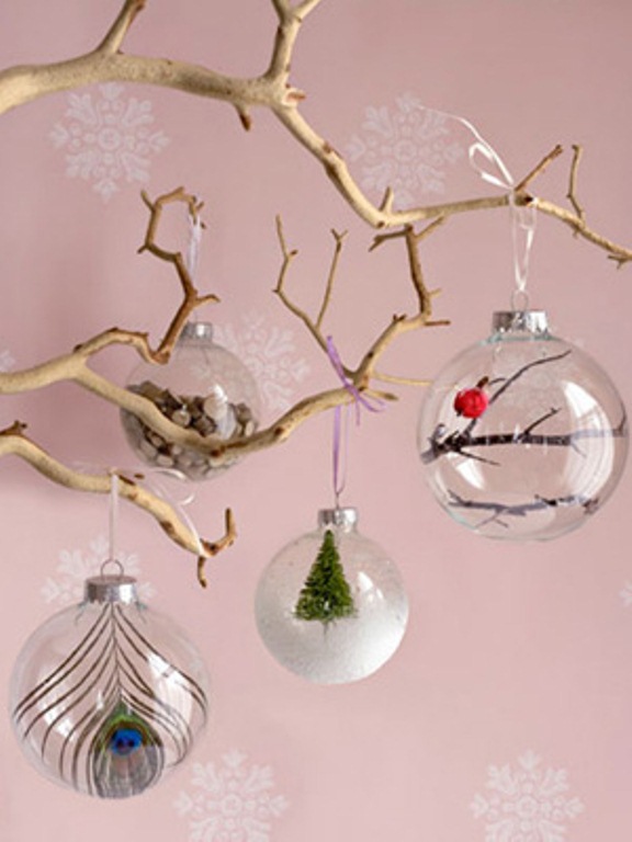 Grab sheer glass ornaments and fill them with whatever you like   feathers, mini trees, faux snow and so on to create a cool combo